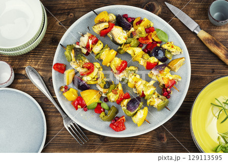 Delicious grilled fish and vegetables on wooden surface. 129113595