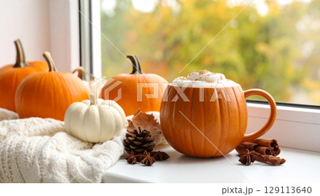 An orange autumn pumpkin and fresh pumpkin mug of coffee 129113640
