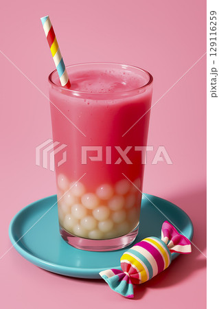 Bright pink fruit drink with tapioca balls at the bottom. Bright background, cooling drink. 129116259