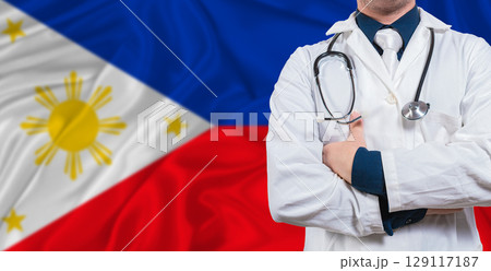Male doctor with stethoscope on Philippines flag. Doctor holding stethoscope on Philippines flag 129117187