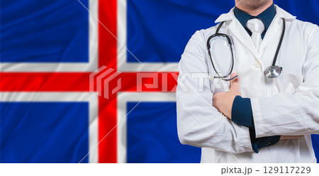 Male doctor with stethoscope on Iceland flag. Doctor holding stethoscope on Iceland flag Male doctor with stethoscope on Iceland flag. Doctor holding stethoscope on Iceland flag 129117229
