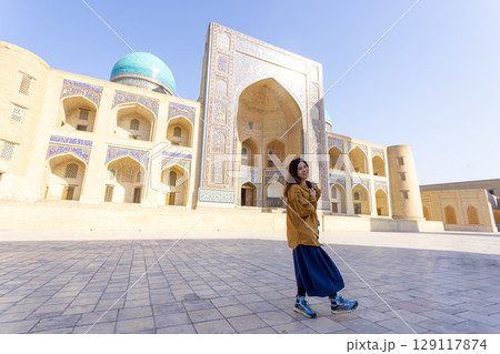 woman as a tourist have fun in front of Poi-Kalyan Kalyan mosque in bukhara Uzbekistan	 129117874