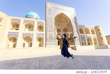 woman as a tourist have fun in front of Poi-Kalyan Kalyan mosque in bukhara Uzbekistan	 129117875