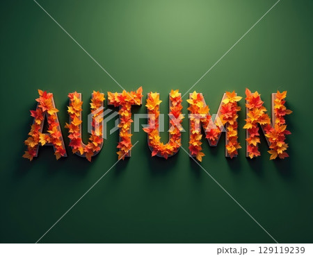 Autumn text made with orange and yellow maple leaves on green background 129119239