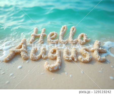 turquoise sea water on sand beach with text made with white pebbles 'Hello August' 129119242