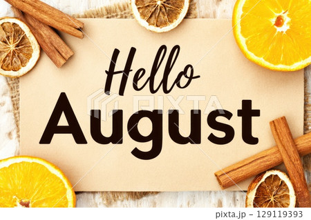 Hello August banner with orange slices and cinnamon sticks on natural background Hello August banner with orange slices and cinnamon sticks on natural background 129119393