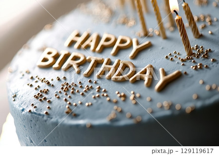 Minimalist designer birthday cake. Light blue icing is decorated with gold glitter and the words "Happy Birthday". Greeting card concept. Pastry advertising, party banners. Family celebration. Banner 129119617