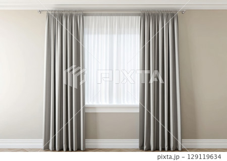 Bright modern interior with large window framed by elegant gray curtains. Natural light flows into the minimalist room with beige walls and wooden flooring, ideal for home decor or curtain showcase Bright modern interior with large window framed by elegant gray curtains. Natural light flows into the minimalist room with beige walls and wooden flooring, ideal for home decor or curtain showcase 129119634