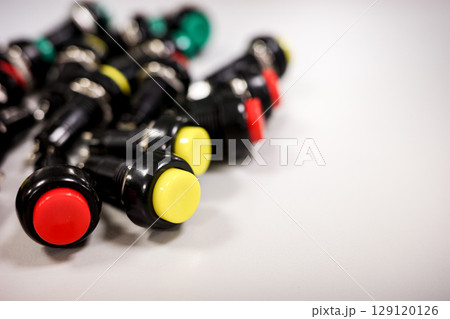 Electronic push buttons on white background 129120126