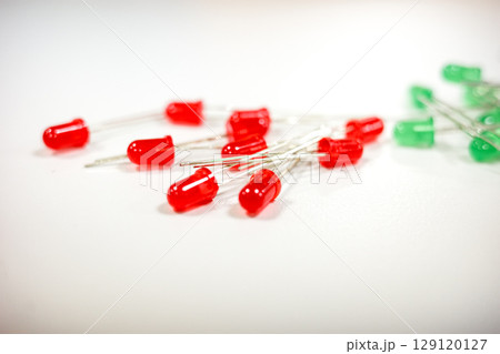 Red and green LEDs electronic components on white background 129120127