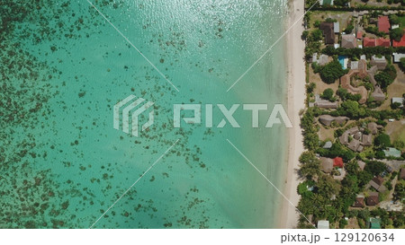 Stunning aerial top down view showcasing the idyllic beauty of Tahiti coastline, with crystal clear turquoise water, pristine white sand beach, lush tropical vegetation, houses, resorts and hotels Stunning aerial top down view showcasing the idyllic beauty of Tahiti coastline, with crystal clear turquoise water, pristine white sand beach, lush tropical vegetation, houses, resorts and hotels 129120634