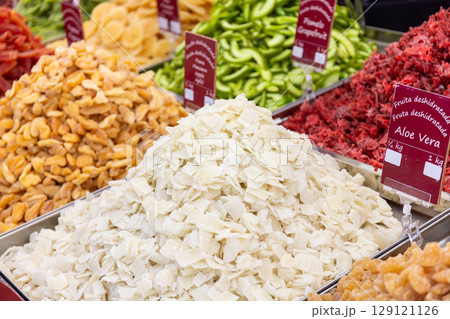 Selection of dried fruits like aloe vera, apple and other offered at a market stall 129121126