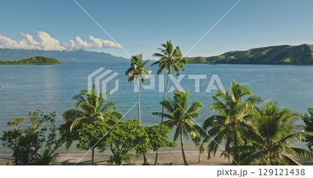 Fiji islands: Aerial of a Fiji tropical beach with palm trees, turquoise water and small islands in the South Pacific Ocean, creating a breathtaking view of paradise. Drone flight 129121438