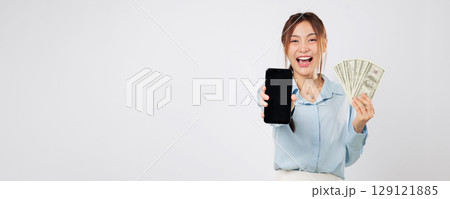Excited woman showing smart phone screen, happy with money, mobile app money success representing modern finance power, holding dollar banknotes with proud energy. isolated studio white background Excited woman showing smart phone screen, happy with money, mobile app money success representing modern finance power, holding dollar banknotes with proud energy. isolated studio white background 129121885