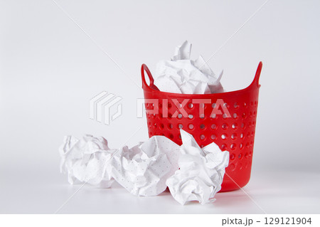 Trash can. Full basket. Crumpled paper in a basket. 129121904