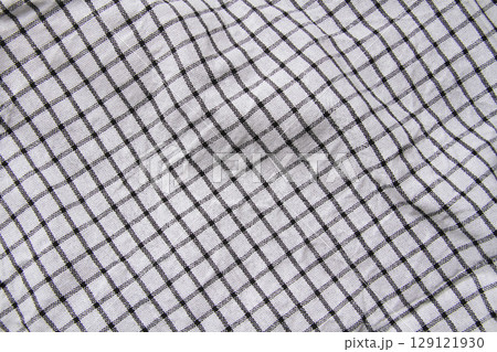 Plaid material. Towel on the table. Wrinkled fabric with stripes. 129121930