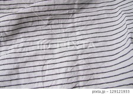 Plaid material. Towel on the table. Wrinkled fabric with stripes. 129121933