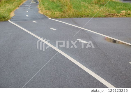 A scenic curved pathway with vibrant green surroundings, perfect for exploration and recreation A scenic curved pathway with vibrant green surroundings, perfect for exploration and recreation 129123236