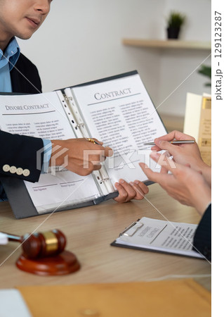 Legal Consultation. Lawyer and client reviewing divorce contract details. Legal Consultation. Lawyer and client reviewing divorce contract details. 129123287