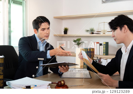 Legal Advice. Lawyer presenting divorce contract details to client. 129123289