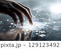 未来技術に触れる手、波紋のように広がる光のインターフェース 129123492