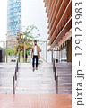 Man walking down stairs in modern city architecture 129123983