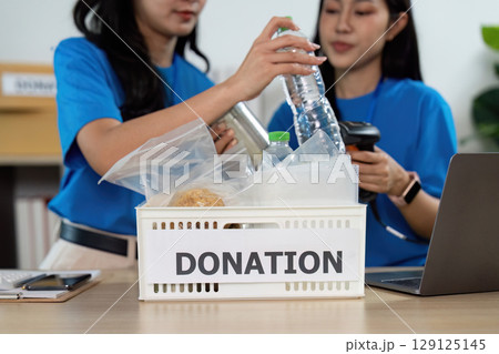 Volunteers sorting donations, preparing for community outreach Volunteers sorting donations, preparing for community outreach 129125145