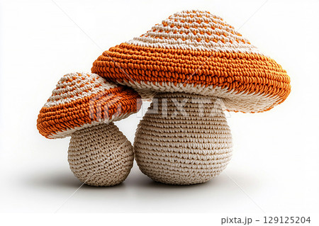 Ready to Create. Autumn Knits. Crocheted bright mushrooms on a white background. Autumn atmosphere. Creative hobby. Ready to Create. Autumn Knits. Crocheted bright mushrooms on a white background. Autumn atmosphere. Creative hobby. 129125204