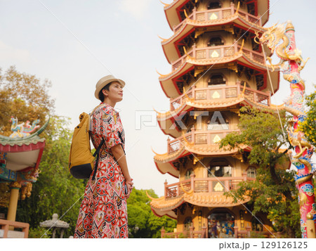 Woman Exploring Colorful Streets Near Buddhist Temples in Bangkok Woman Exploring Colorful Streets Near Buddhist Temples in Bangkok 129126125
