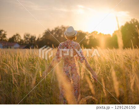 boho chic woman in a floral dress in European countryside 129126150