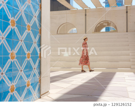 Young female tourist exploring iconic landmarks of the United Arab Emirates. Young female tourist exploring iconic landmarks of the United Arab Emirates. 129126152