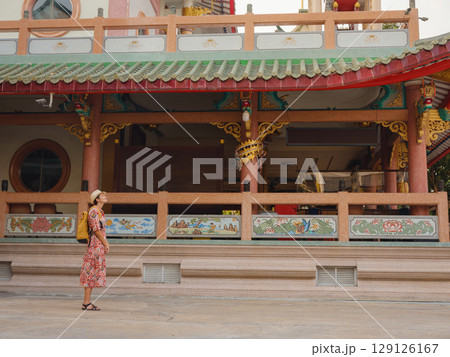 Woman Exploring Colorful Streets Near Buddhist Temples in Bangkok Woman Exploring Colorful Streets Near Buddhist Temples in Bangkok 129126167
