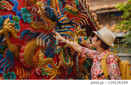 Woman Exploring Colorful Streets Near Buddhist Temples in Bangkok Woman Exploring Colorful Streets Near Buddhist Temples in Bangkok 129126169