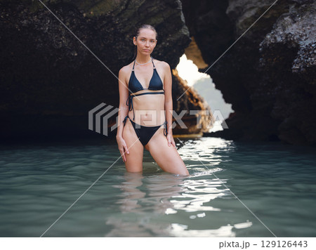 Young woman enjoying serene evening at sea in Krabi, Thailand 129126443