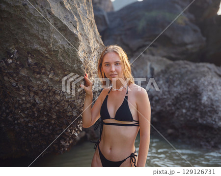 Young woman enjoying serene evening at sea in Krabi, Thailand 129126731
