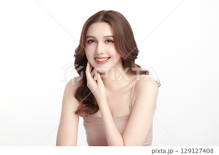 A beautiful young Asian woman with clean, fresh skin against a white background. Skincare, facial treatment, cosmetology, beauty, and spa. An elegant portrait of an Asian woman. A beautiful young Asian woman with clean, fresh skin against a white background. Skincare, facial treatment, cosmetology, beauty, and spa. An elegant portrait of an Asian woman. 129127408