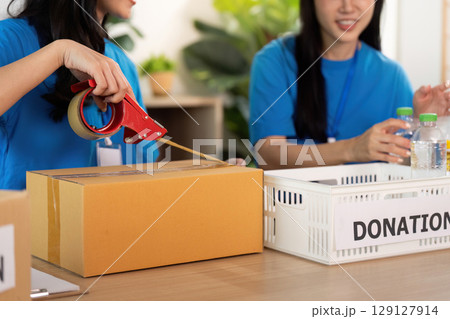 Volunteer organizing donations with care and teamwork 129127914