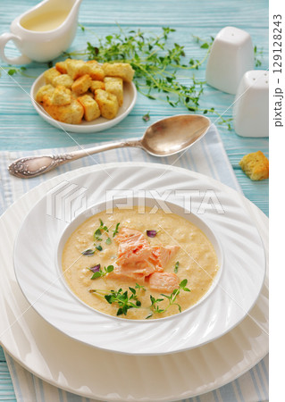creamy salmon soup with herb in a bowl 129128243
