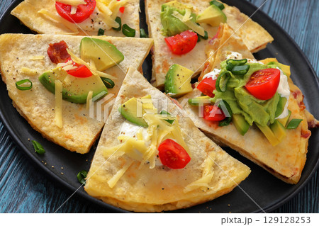 quesadilla with cheese, bacon, avocado on a plate quesadilla with cheese, bacon, avocado on a plate 129128253
