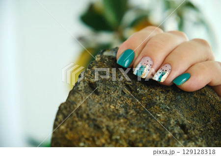 Female hands with green nail design. Female hands with green nail design. 129128318