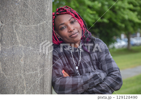 Mature African Woman Arms Crossed Concrete 129128490