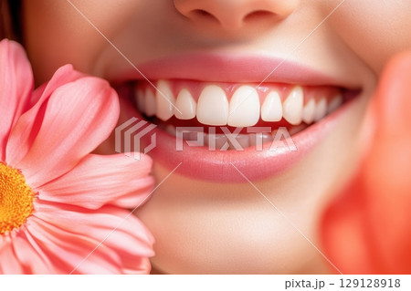 Close-up of perfect white teeth and healthy pink lips. Bright natural smile. Clean and shiny enamel. Concept of oral hygiene, cosmetic dentistry, and beauty care. Minimal background. Banner 129128918