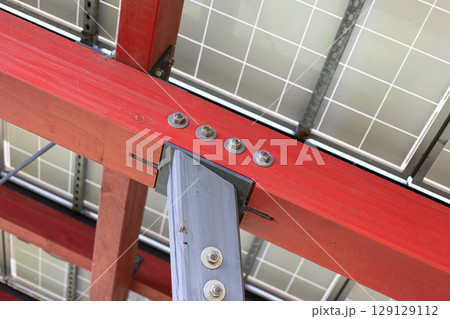 constructive detail of a wood and metal structure used to support solar panels 129129112