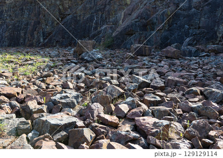 Rocky background forming an arid landscape at the foot of a mountain Rocky background forming an arid landscape at the foot of a mountain 129129114