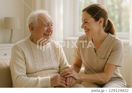 Caring Caregiver Assisting Elderly Man in Comfortable Setting Caring Caregiver Assisting Elderly Man in Comfortable Setting 129129822