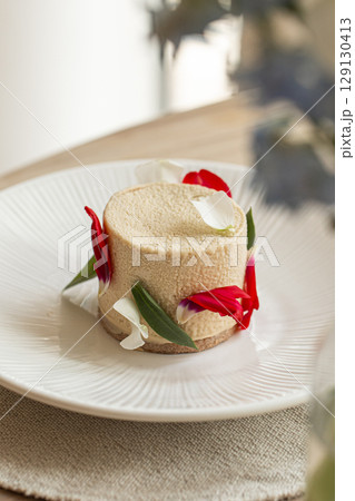 Elegant mousse dessert with flower petals 129130413