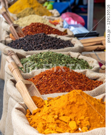 Colorful Spices in Burlap Sacks with Wooden Scoops at Open Market Display Colorful Spices in Burlap Sacks with Wooden Scoops at Open Market Display 129130516