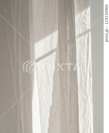 Close Up of White Linen Curtain with Sunlight Filtering Through Window for Backdrop 129130960
