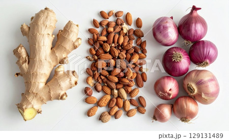 Overhead Shot of Ginger Almonds and Red Onions on a White Background 129131489
