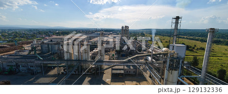 Aerial view of oil and gas refining petrochemical factory with tall refinery plant manufacture structure. 129132336